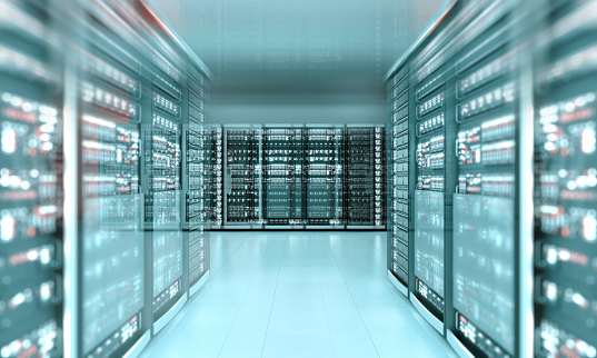 Modern data center with futuristic computer servers aligned in a corridor glowing with blue neon light. Digitally generated image.