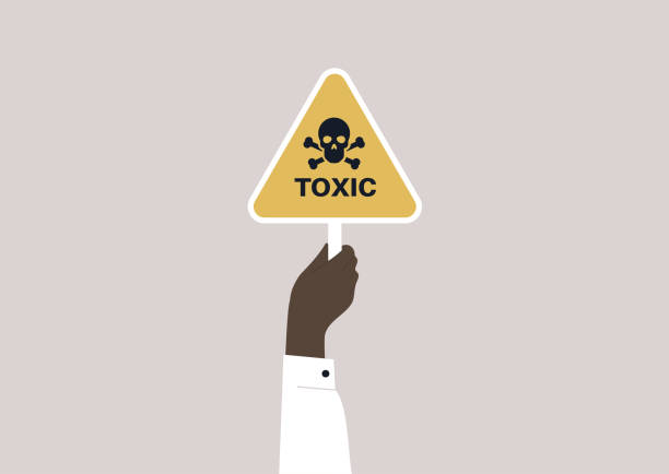 ręka trzymająca żółty trójkąt toksyczny znak z czaszką i skrzyżułymi kośćmi - nuclear power station danger symbol radioactive stock illustrations
