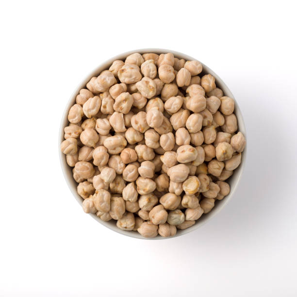 istock White round pot full of uncoked chickpea. isolated on white. top view. 1340509715