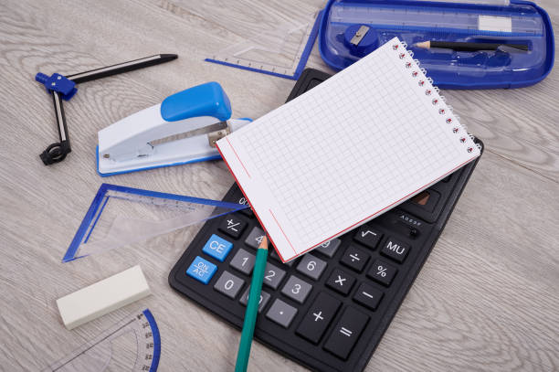 istock Blank Notebook Page With A Calculator And Geometric Stationery Sets On Top Of A Table. Empty Lined Notepad With Calculation Compass Office Supplies Over Desk. 1340510266