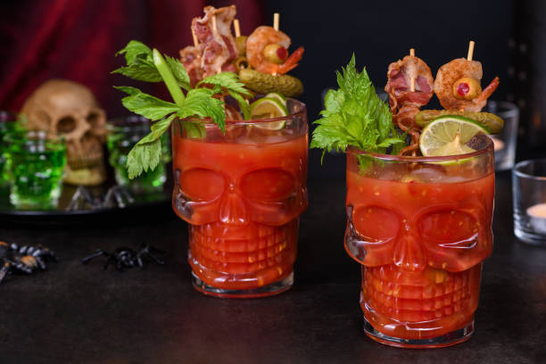 Creepy Halloween party - Caesar or Bloody Mary cocktail containing vodka, some tomato juice, different spices and flavorings, such as Worcestershire sauce, celery. Served with ice in a beer glass stock photo