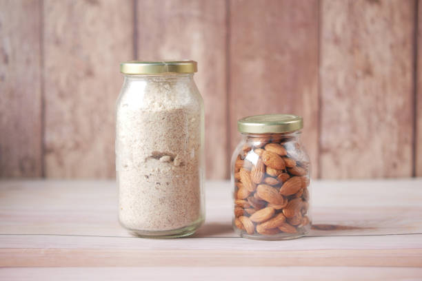 istock almond powder and almond in a jar on table, 1340511132
