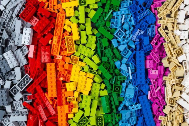 top view pile of many various colorful rainbow colored stackable plastic toy bricks. childhood education development concept