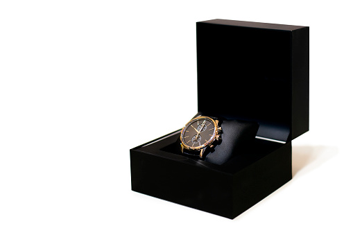 Expensive wristwatch in a black box, isolated on white background.