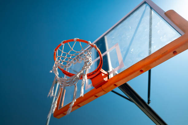 istock Basketball hoop close up outdoors. Blue sky on background 1340514029