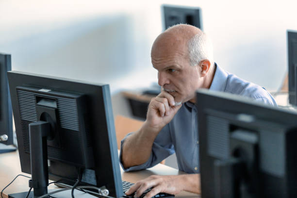 istock Hardworking businessman concentrating on his desktop computer 1340515035