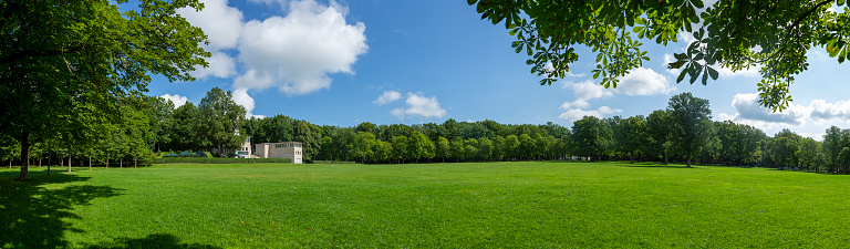 Panorama of a large city public park during a summer day