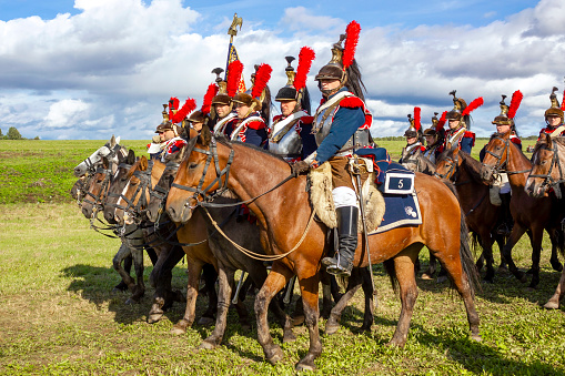 Borodino, Moscow Region, Russia - September 05, 2021: The Napoleonic war reenactors riding horses at the Borodino battle reenactment.