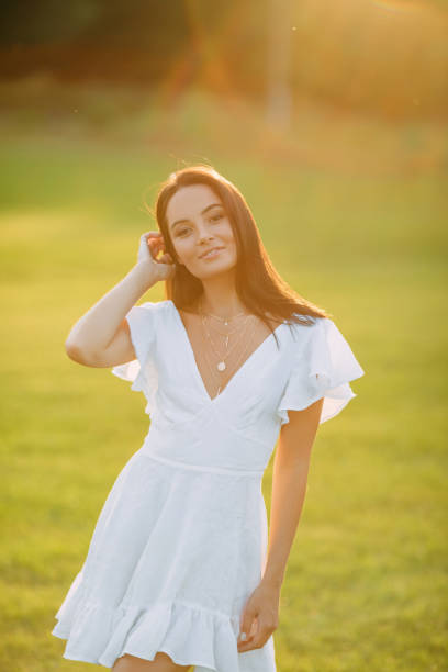 istock Young joyful woman walks in meadow at sunset. 1340519981
