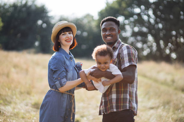istock Multiracial parents having fun with little son on nature 1340520002