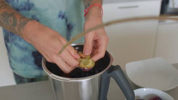 istock He breaks plums and puts them blender kitchen. Preparation vitamin cocktail 1340520035
