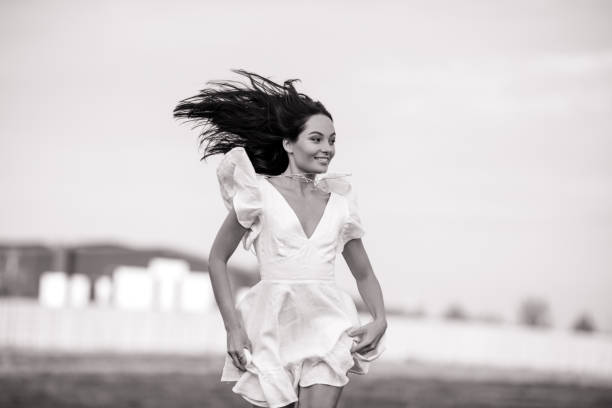 istock Young joyful woman runs in meadow. 1340520085