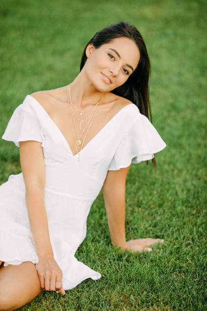 istock Young joyful woman rests on grass. 1340520148