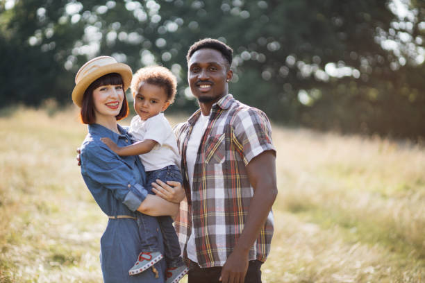 istock Adorable multiracial parents posing with cute son on field 1340520149