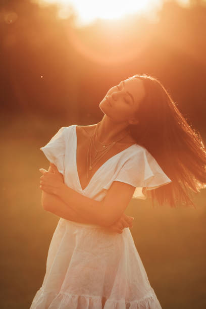 istock Young woman walks in meadow at sunset. 1340520266