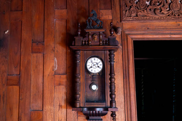 istock antique pendulum clock hanging on the wooden wall 1340521441