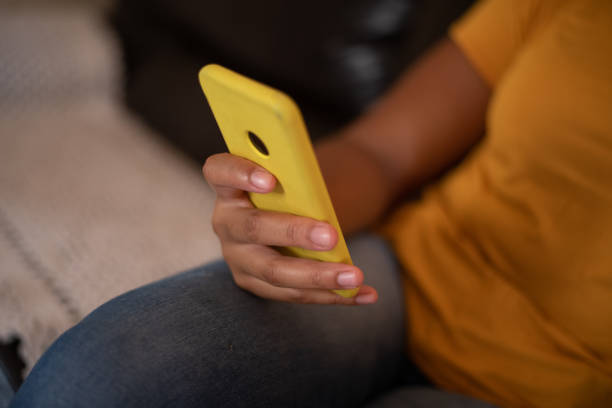 istock Woman on sofa with cell phone. 1340521905