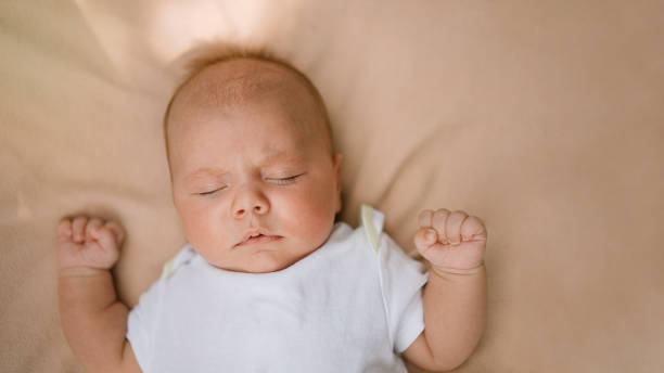 istock Newborn baby sleeps on soft bed. 1340522129