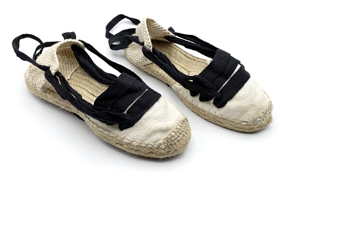 Some handmade espadrilles, typical rural Aragonese footwear, used for the field and dance called jota, wooden background