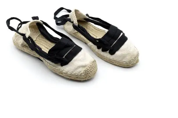 Photo of Some handmade espadrilles, typical rural Aragonese footwear, used for the field and dance called jota, wooden background