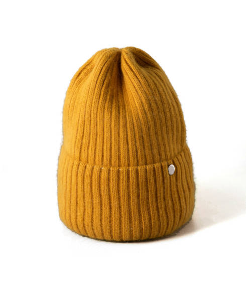 istock Small yellow knitted hat on white isolated background. woolly hat Closeup. 1340523286
