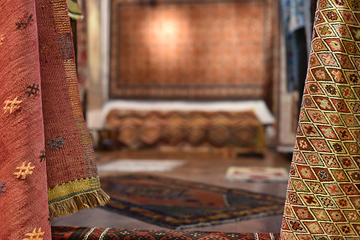 Turkish vintage carpets store in selective focus with blurry background in center
