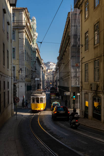 A traditional tram in a street at the downtown of the city of Lisbon Lisbon, Portugal - January 5, 2015:  A traditional tram in a street at the downtown (Baixa) of the city of Lisbon, Portugal. baixa stock pictures, royalty-free photos & images