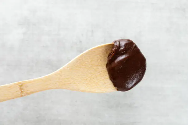 Brazilian vegan Brigadeiro chocolate on a wooden spoon