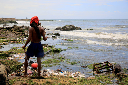 salvador, bahia, brazil - january 11, 2021: pollution and garbage on the Costa Azul beach in the city of Salvador. The material is drained into the sewage channel of the Rio Camurugipe and dumped into the sea.