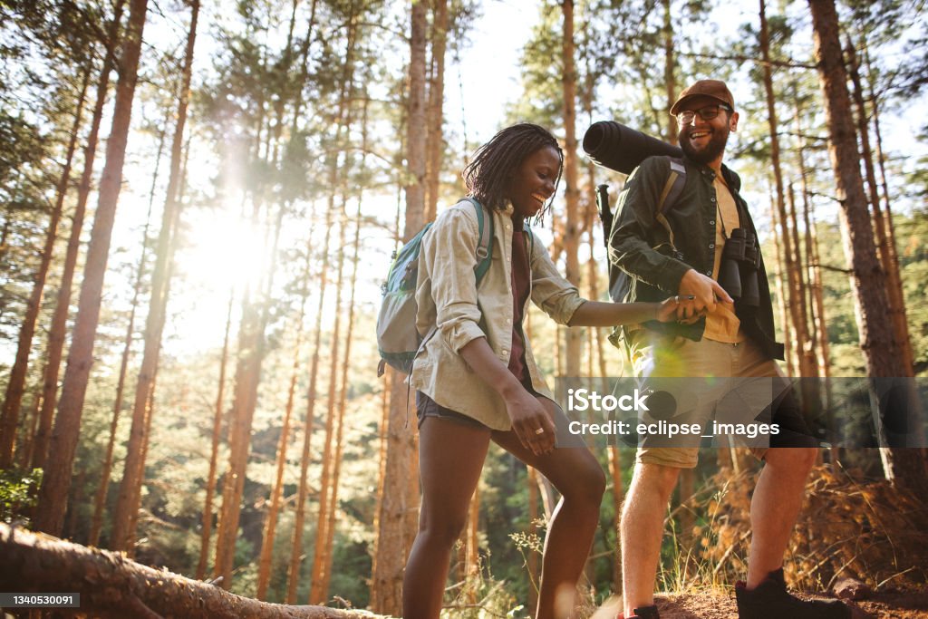 Forest walk and camping adventures Love couple hikers in the forest, walking and speaking for a good place for camping Hiking Stock Photo