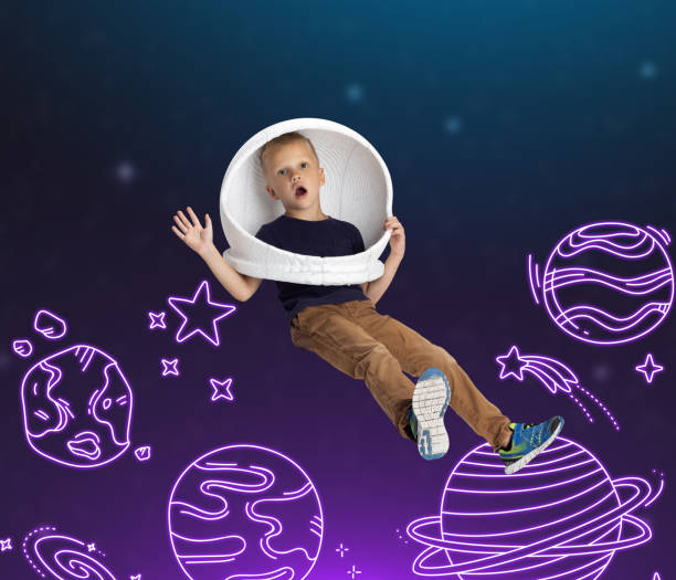 istock Conceptual artwork with little boy in huge white astronaut helmet flying in drawn outer space. Ideas, inspiration, imagination. Collage 1340531653