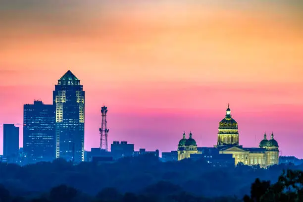 Close-up of the Des Moines skyline and Iowa State Capitol Building at sunset.