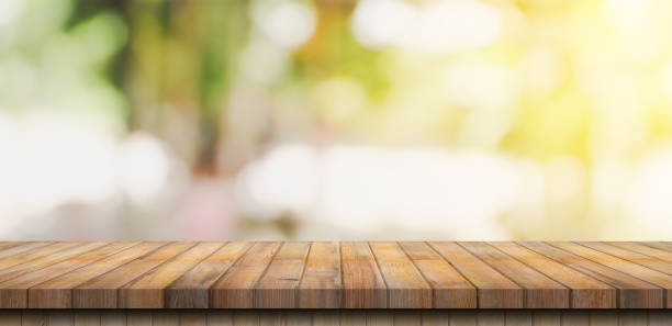 istock Empty wood table and blurred light table in coffee shop and cafe with bokeh background. product display template. 1340535572