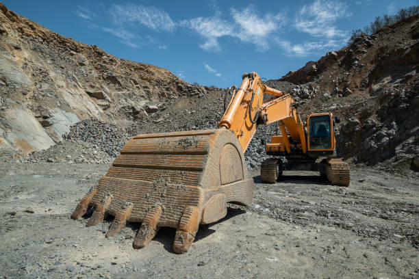 istock Orange excavator in an open-type stone quarry. 1340536550