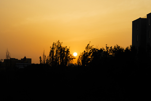silhouettes at sunset in the Carabanchel neighborhood in Madrid, Spain