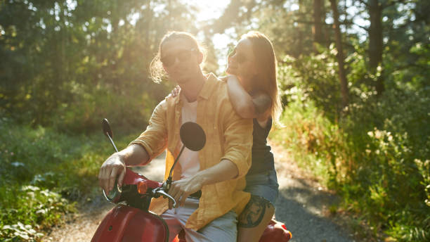 istock Smiling young caucasian couple sitting on scooter 1340542336