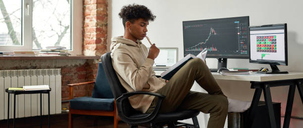 Banner view of ethnic male trader work online on computer stock photo