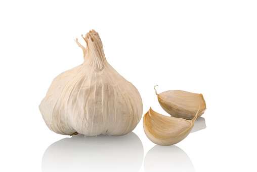 Garlic head with two garlic cloves isolated on white background
