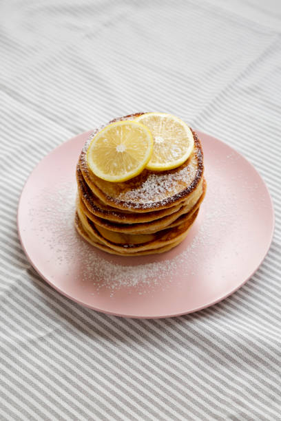 istock Homemade Lemon Ricotta Pancakes on a pink plate, side view. 1340543575