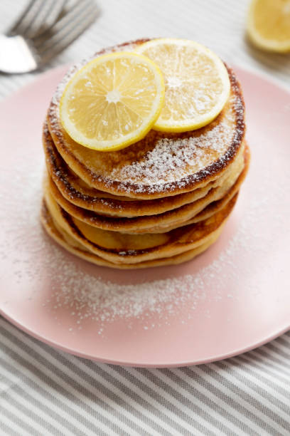 istock Homemade Lemon Ricotta Pancakes on a pink plate, low angle view. 1340543666