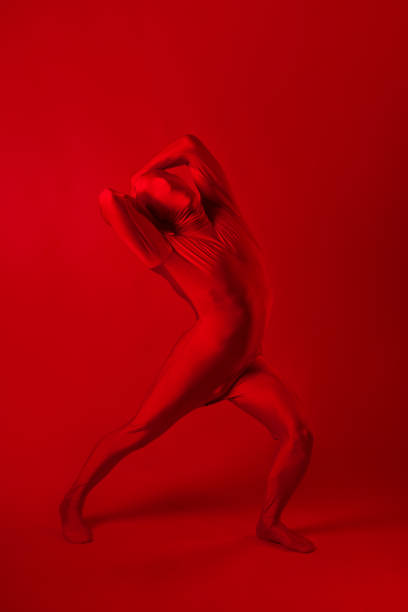istock A screaming man in a red full suit, on a red background. 1340545519
