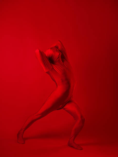 istock A screaming man in a red full suit, on a red background. 1340545527