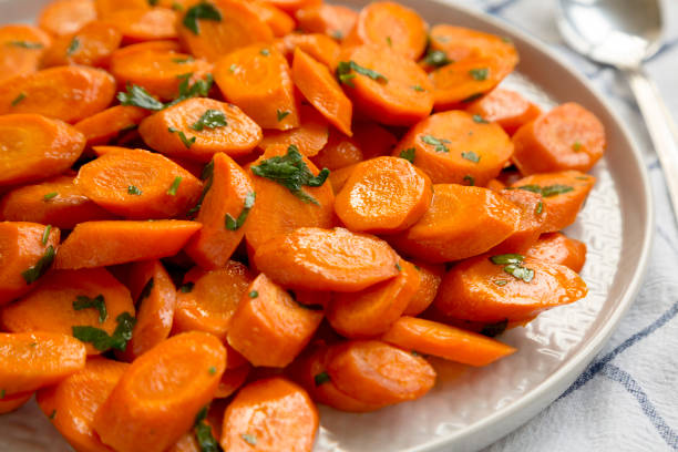 istock Homemade Sauteed Carrots on a plate, side view. Close-up. 1340545584