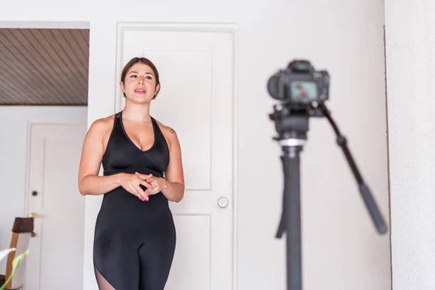 istock Latin woman exercises while being recorded by her camera 1340545600