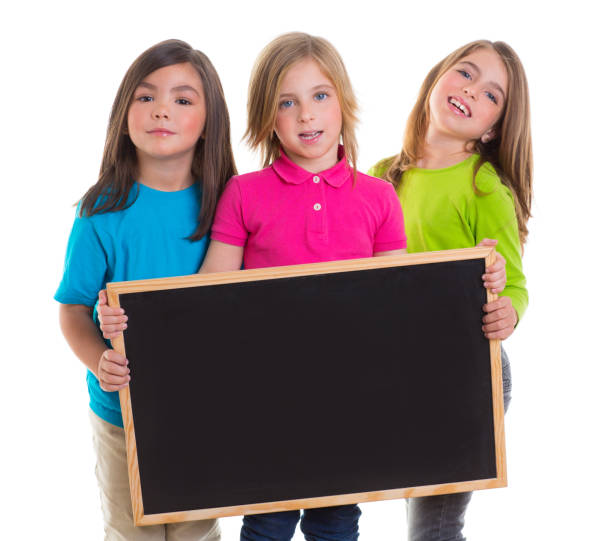 istock children girls group holding blank blackboard copy space 1340547142