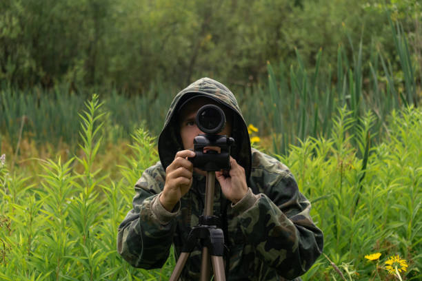 istock man wildlife researcher makes observations in the wild with a spotting scope 1340548974