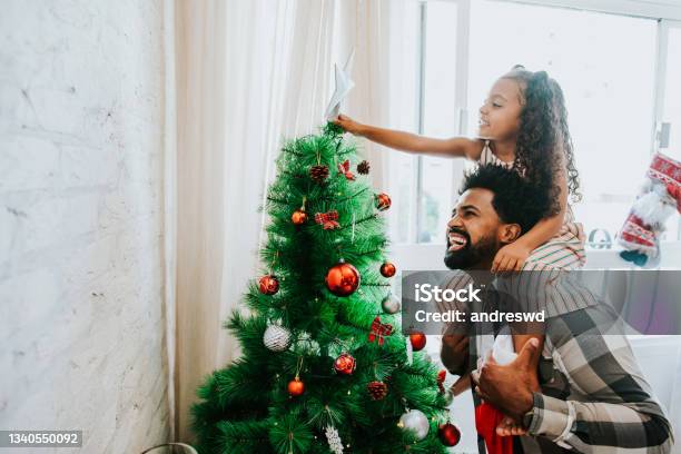 Father And Daughter Decorating Christmas Tree Stock Photo - Download Image Now - Christmas, Family, Brazil
