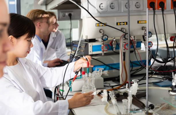 istock Friendly Caucasian and Asian students at lab 1340553254