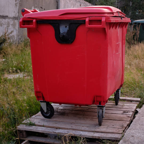 istock Red garbage bin with wheels. Waste container. Public trash. street trash can 1340553387