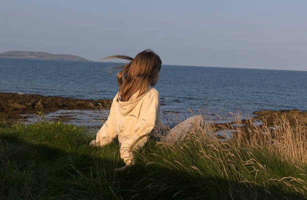 A teenager looking out to sea and maybe wondering what is on the horizon for her future